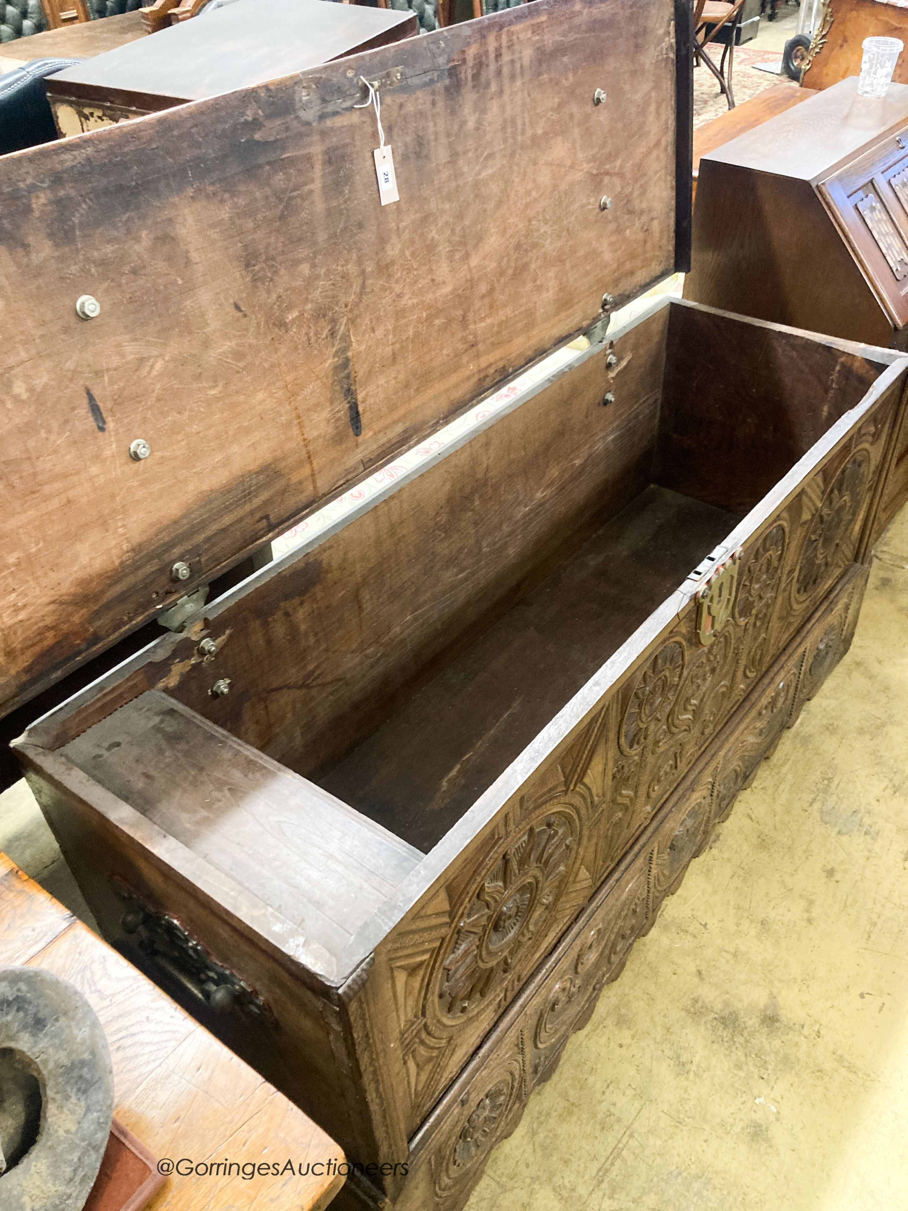 A 17th / 18th century Welsh oak coffer, with carved panelled front and heavy brass strap hinges, W.162cm D.57cm H.78cm